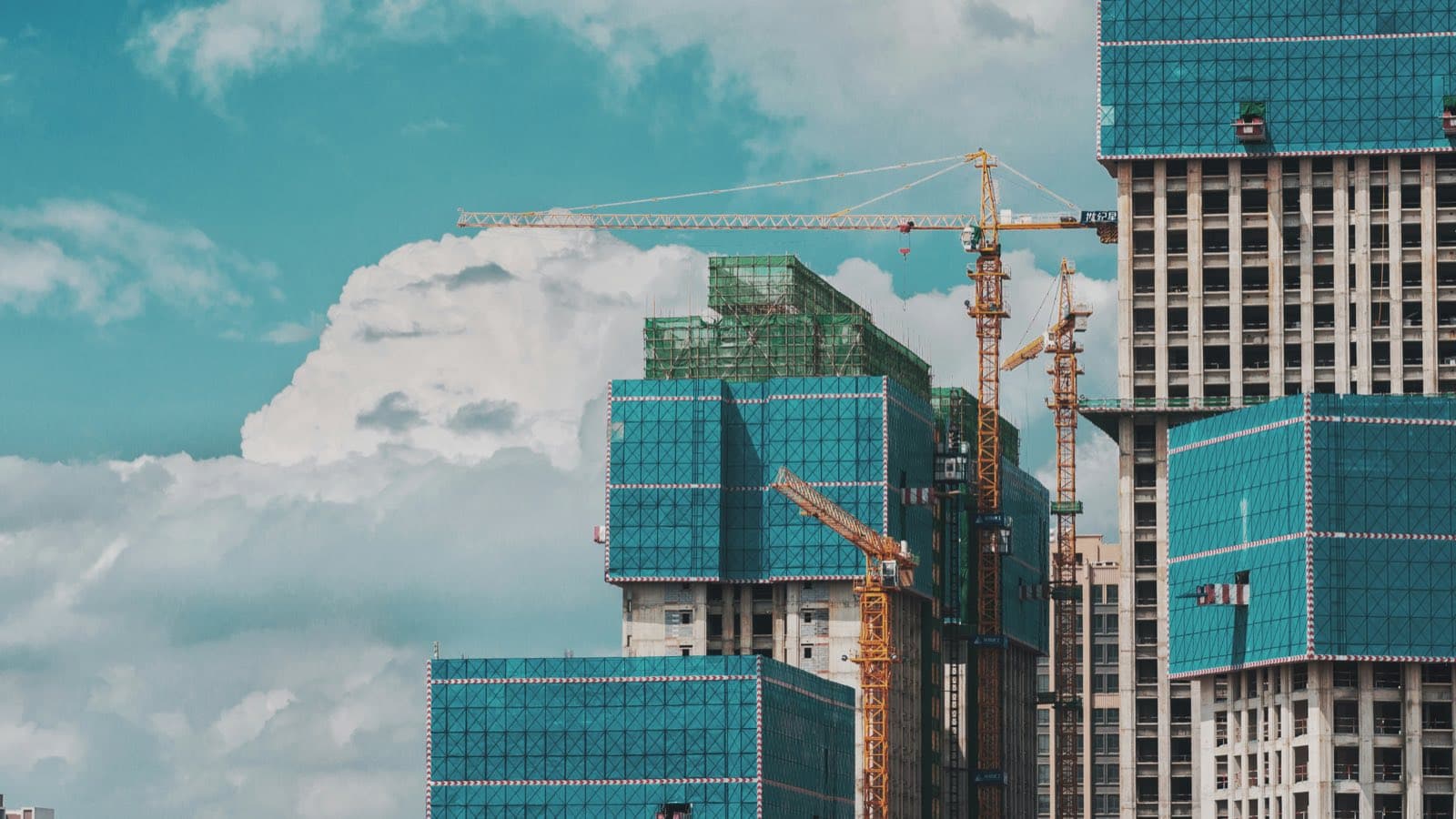 Tower cranes over high rise buildings going up