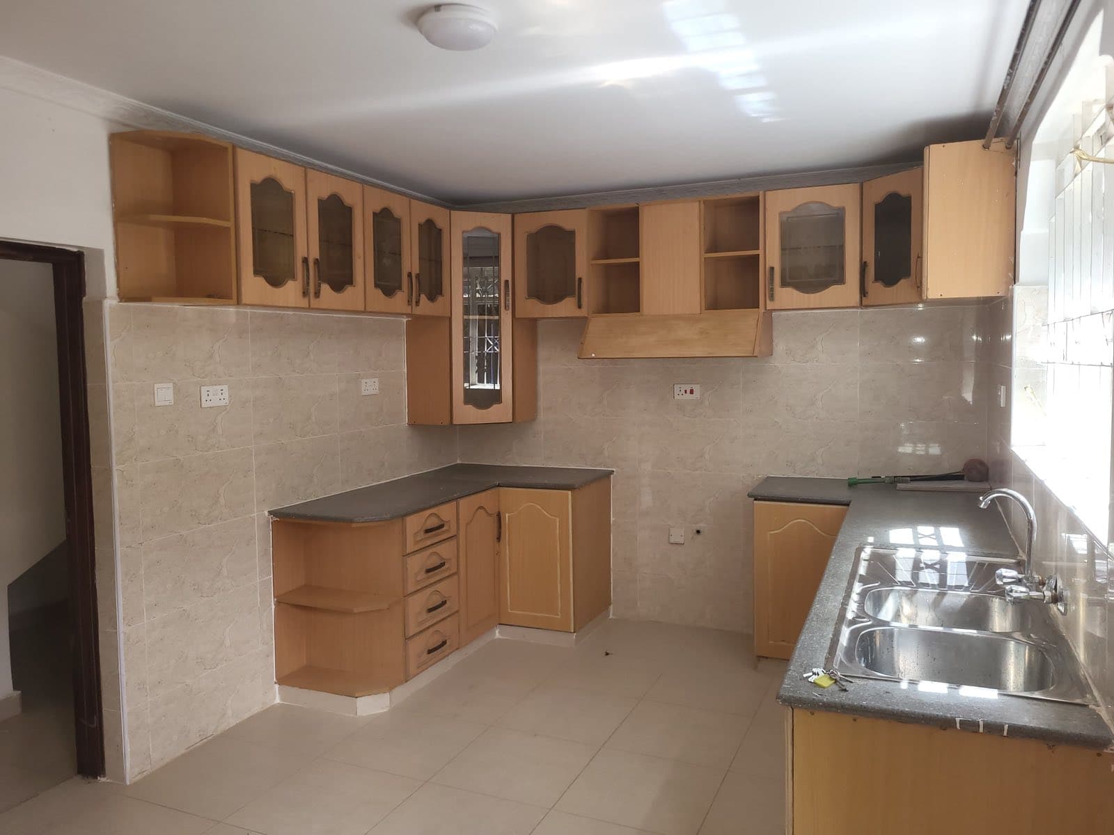 A fitted kitchen with wooden cabinets